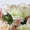 Pastel floral arrangement with pale pink and cream blooms and green-centered flowers