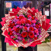 Large bouquet of red and pink roses with purple filler flowers