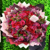Large bouquet of red and pink roses with purple filler flowers