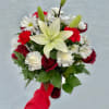 A striking pale cream lily crowns this Red Velvet flower arrangement, rising