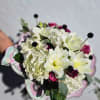 Bouquet of white lilies and pink roses with pale hydrangea