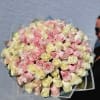 Large bouquet of pale pink and cream roses wrapped in clear paper
