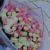 Bouquet of pink and white roses with gold-wrapped chocolates