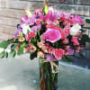 A lush blend of pink roses and soft lavender chrysanthemums creates an