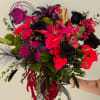 Bouquet of hot pink and black flowers with lilies and roses