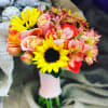 Bouquet of sunflowers, roses, and pink alstroemeria in a wrapped handle