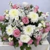 Pink roses and white chrysanthemums arranged in a low bouquet