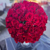 Round bouquet of red roses in a clear vase