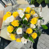 Bouquet of yellow and white roses with purple filler flowers