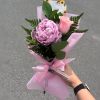 Pink peony and rose bouquet wrapped in pink paper