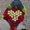 Heart-shaped bouquet of red roses with gold-wrapped chocolates and a black card