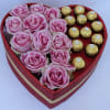 Heart-shaped box with pink roses and gold-wrapped chocolates