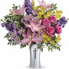 At once radiant and reverent, this colorful bouquet of roses, lilies and