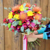 Bright mixed bouquet with yellow, pink, and orange flowers