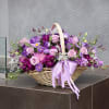Basket of purple and pink flowers with a lavender ribbon