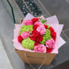 Pink and red rose bouquet with green hydrangeas in a cardboard gift box
