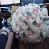 Large bouquet of pink and white roses in a car seat