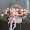 Pink and peach flower basket with a ribbon bow