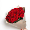 Bouquet of red roses wrapped in beige paper
