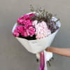 Pink rose and hydrangea bouquet wrapped in white paper