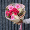Pink gerbera and rose bouquet with white hydrangea in pastel wrap