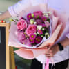 Pink rose bouquet wrapped in pale pink paper