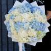 Large bouquet of blue and white hydrangeas wrapped in white paper