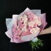 Bouquet of pink and cream carnations wrapped in pastel paper