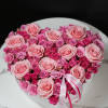 Heart-shaped box of pink roses and spray roses with ribbon