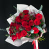 Bouquet of red roses wrapped in white paper