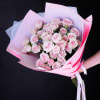Bouquet of pale pink roses wrapped in pink paper
