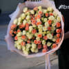 Large bouquet of cream and peach roses wrapped in pink paper