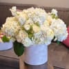 White floral arrangement in a round white vase