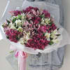Bouquet of pink, white, and magenta alstroemeria wrapped in white paper