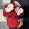Red rose bouquet with white orchids in a red hat box