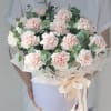 Bouquet of pale pink carnations with eucalyptus in a lavender box
