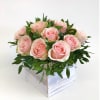 Pink roses arranged in a white wooden box