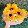 Yellow roses and sunflowers in a pink wrapped bouquet with butterfly accents