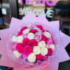 Bouquet of pink and white roses wrapped in pink paper