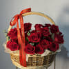 Basket of red roses with a red ribbon