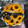 Bouquet of bright yellow sunflowers with a black ribbon bow