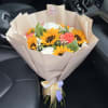 Bouquet of sunflowers, white chrysanthemums, and pink carnations wrapped in beige paper