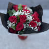 Bouquet of red roses with white baby's breath in black wrap