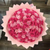Large bouquet of pink and hot pink roses wrapped in pale pink paper