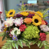 Basket arrangement with sunflowers, roses, hydrangea, and carnations