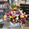 Includes a variety of flowers in a basket arrangement