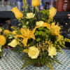 About a medium basket full of yellow mixed flowers
