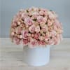 Round bouquet of pale pink roses in a white box