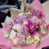 Pink and white bouquet with lilies and roses wrapped in pink paper