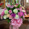 Bouquet of pink and pastel carnations with a pink ribbon bow
